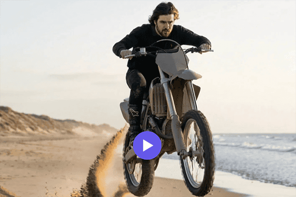 AI Video Experiences for Events: The Next Big Thing in Event Entertainment 3 AI Video: A person rides a dirt bike at high speed along a sandy beach, with sand flying up behind the rear wheel.